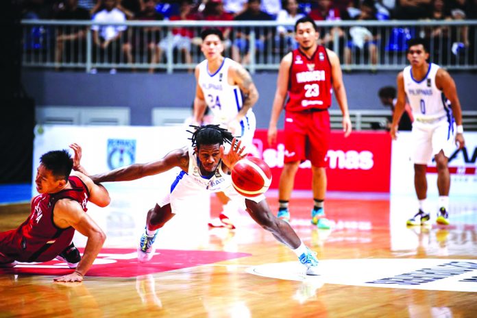 Gilas Pilipinas’ guard CJ Perez hustles for the ball while being challenged by an Indonesian defender during the two countries’ clash last night in Jakarta, Indonesia. FIBA