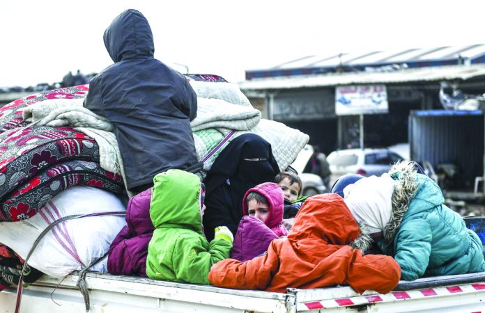 Civilians flee from Idlib toward the north to find safety inside Syria near the border with Turkey, Saturday, Feb. 15, 2020. Syrian troops are waging an offensive in the last rebel stronghold. AP