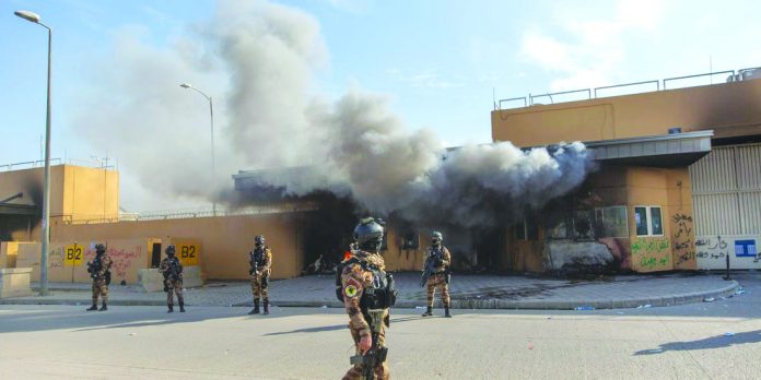 Iraqi army soldiers are deployed in front of the United States embassy, in Baghdad, Iraq. AP