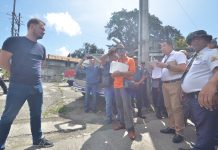 Panay Electric Co. administrative manager Marcelo Cacho (left) refuses to receive from court sheriffs the Writ of Possession issued by the court. IAN PAUL CORDERO/PN