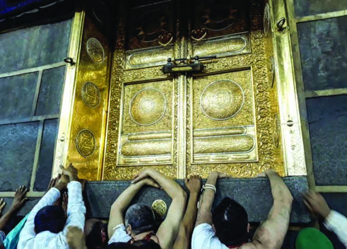 Muslims pilgrims gather outside the door of the Kaaba, Islam's holiest shrine, in Mecca, Saudi Arabia. AFP