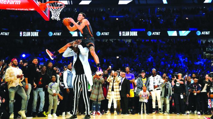 Orlando Magic's Aaron Gordon soars past seven-foot-five Boston Celtics center Tacko Fall for his final trick of the 2020 All-Star Slam Dunk competition in Chicago, USA on Feb. 15. YAHOO SPORTS