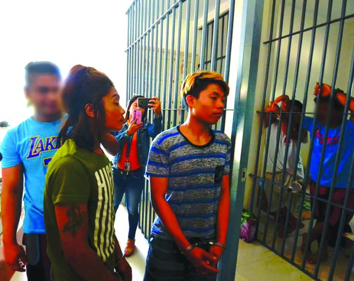 Murder suspects (from right) Renesto and Rene Boy Suspeno and a 16-year-old minor are being escorted to the lockup facility of municipal police station of Miag-ao, Iloilo on Feb. 25. IAN PAUL CORDERO