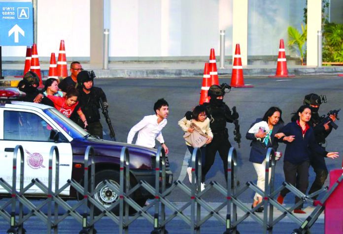 Thai security forces evacuate people who were stranded inside the Terminal 21 shopping mall following a gun battle, to try to stop a soldier on a rampage after a mass shooting, Nakhon Ratchasima, Thailand Feb. 9, 2020. REUTERS