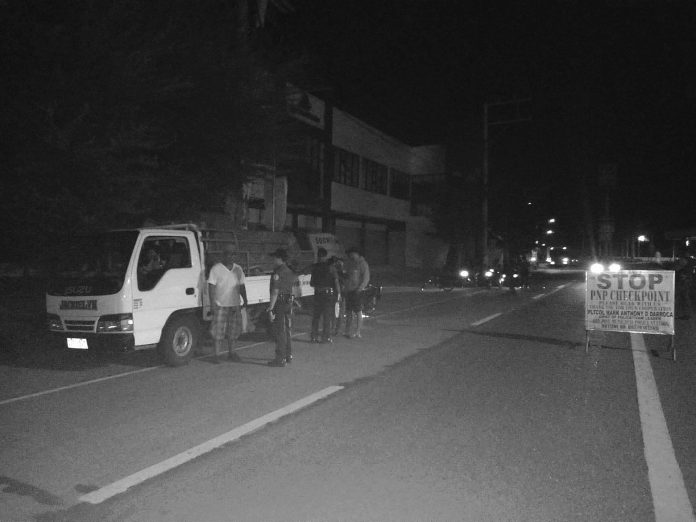 Police officers inspect the transport truck of Edwin Gerona, Jake Gerona and Nolasco Cahilig Jr containing 3,100 liters of gasoline in 155 drums. STEPHEN LOUIE CHECA/PN