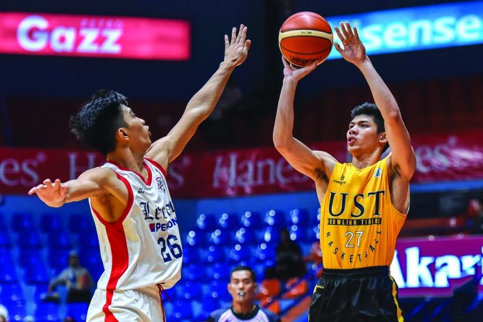 University of Santo Tomas Growling Tigers’ Crispin John Cansino shoots a jumper over a Letran Knights defender. TIEBREAKER TIMES