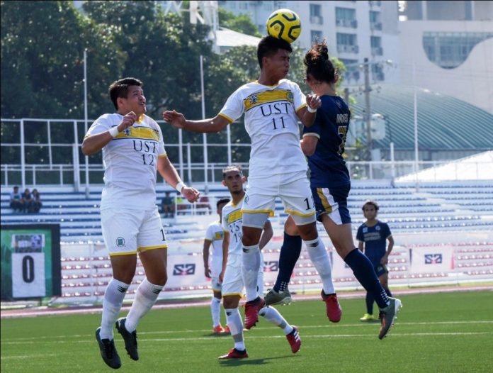 University of Santo Tomas Growling Tigers’ AJ Pasion battles a National University Bulldogs player for the ball. UAAP PHOTO