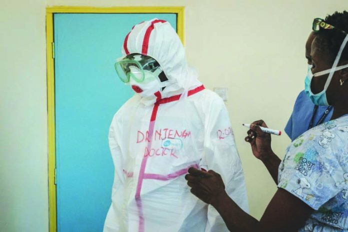 A doctor gets suited up for visiting a quarantine ward at Kenyatta National Hospital in Nairobi. AFP