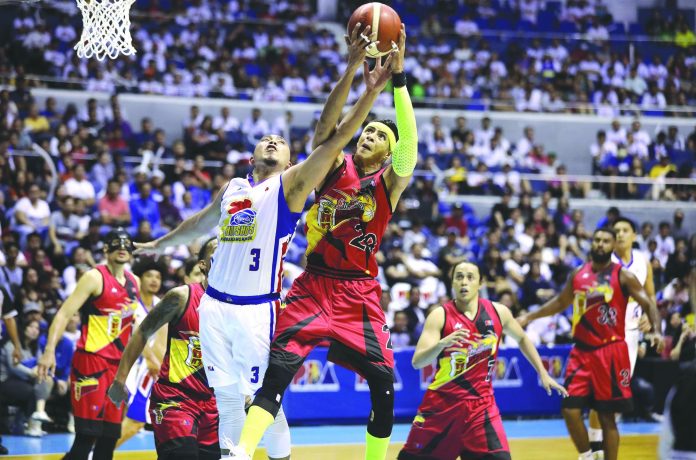 San Miguel Beermen’s (SMB) Arwin Santos soars high to beat Magnolia’s Paul Lee for a rebound in the two teams’ clash at the start of the 2020 Philippine Basketball Association Cup at the Smart Araneta Coliseum last night. SMB defeated Magnolia by way of an overpowering 94-78 performance. PBA