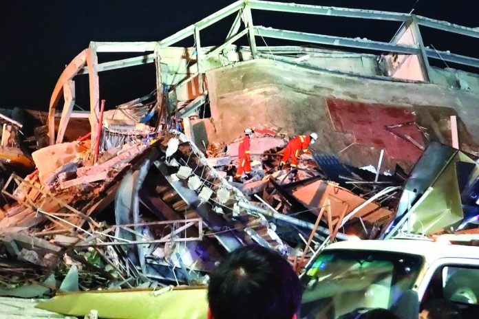 Rescue workers are seen on the site where a hotel being used for the quarantine of the coronavirus disease-2019 collapsed in the southeast Chinese port city of Quanzhou, Fujian province, China March 7, 2020. REUTERS