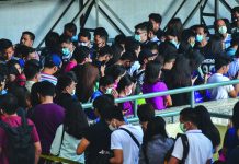 Commuters queue at the MRT North Ave Station in Quezon City on March 13, 2020, a day after President Rodrigo Duterte announced a resolution that places Metro Manila on "Community Quarantine" starting March 15. MARK DEMAY/ABS-CBN NEWS