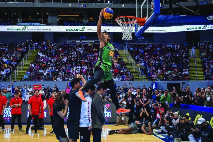 Filipino “dunk artist” David Carlos performs a posterizer slam during a dunk competition. He is set to compete in two slam dunk competitions in this province later this month. ABS-CBN SPORTS