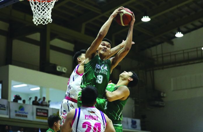 EcoOil-De La Salle University Green Archers’ Justine Baltazar emphatically grabs a rebound against a Karate Kid-CEU Scorpions defender. PBA