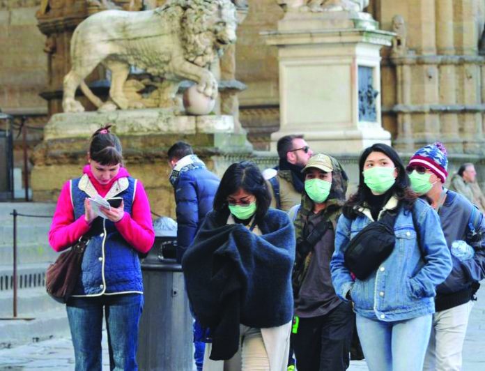 People wearing protective masks walk through Florence as Italy battles a coronavirus outbreak, in Florence, Italy, March 7, 2020. People wearing protective masks walk through Florence as Italy battles a coronavirus outbreak, in Florence, Italy, March 7, 2020. REUTERS