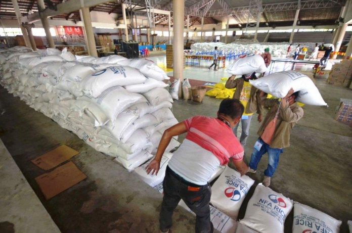 At the Jaro district gymnasium, personnel of the Iloilo City Government prepare these sacks of rice donated by the private sector for repacking and distribution to residents economically displaced by the enhanced community quarantine being observed to stop the spread of the coronavirus disease 2019. IAN PAUL CORDERO/PN