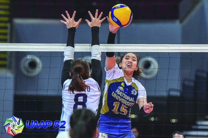 National University Lady Bulldogs’ Audrey Paran attempts a drop shot to evade an Adamson University Lady Falcons defender during the two teams’ matchup in UAAP Season 82 Women’s Volleyball at the SM Mall of Asia Arena on Sunday. Paran’s team swept Adamson in three straight sets. UAAP