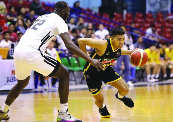 Negrense Mark Nonoy of Builders Warehouse UST Growling Tigers tries to get pass the defense of Papa Ndiaye of the Technological Institute of the Philippines Engineers. PBA