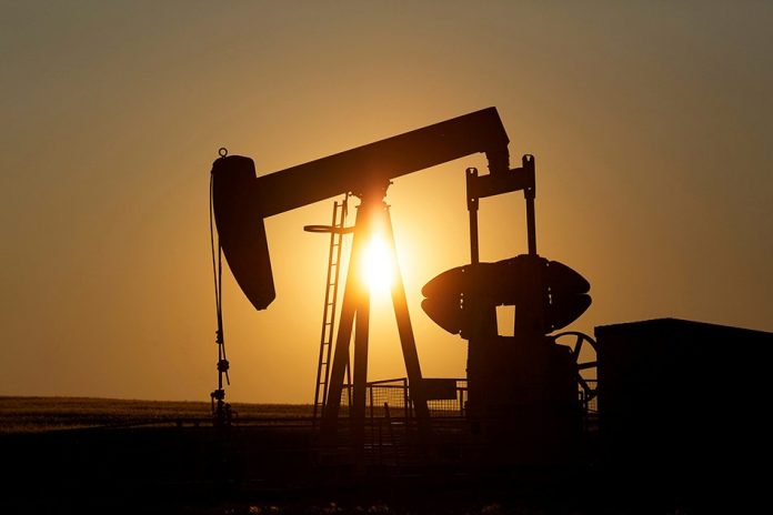 An oil pump jack pumps oil in a field near Calgary, Alberta, Canada on July 21, 2014. REUTERS