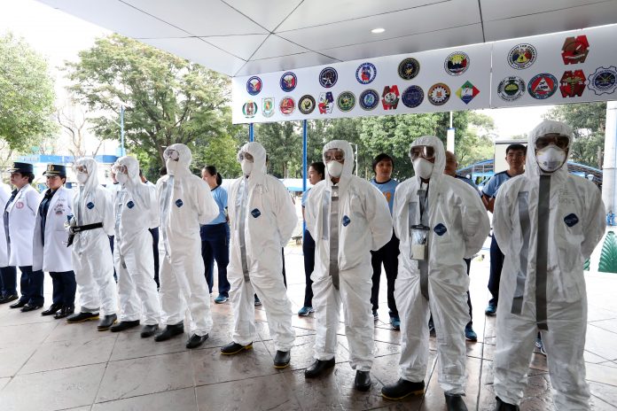 FIGHT VS. CORONAVIRUS. Chemical, biological, radiological, nuclear and explosives (CBRNE)-trained personnel of the Philippine National Police (PNP) from its health service unit are ready to assist other government agencies in the repatriation of Filipinos in China and other countries affected by the 2019 novel coronavirus. Some of the personnel who are ready for deployment don face masks and protective clothing during an event after the flag-raising ceremony at the PNP Headquarters in Camp Crame on Feb. 3, 2020. PNA