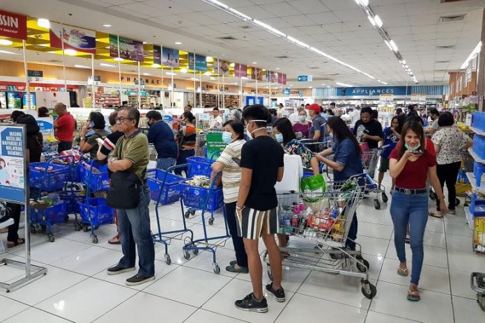 Shoppers endured long queues at checkout counters in groceries and supermarkets in Manila yesterday as word that a lockdown would be enforced set off panic buying across Metro Manila. Shelves were emptied quickly, with sanitisers, disinfectants, rice and cooking oil among the most sought-after items. EPA-EFE