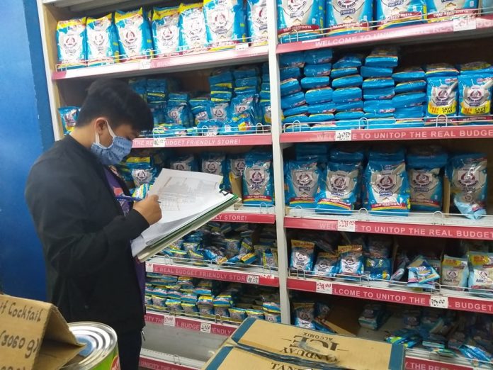 Staff of Department of Trade and Industry monitors prices and supplies of basic necessities at a store in Antique’s San Jose town. PIA