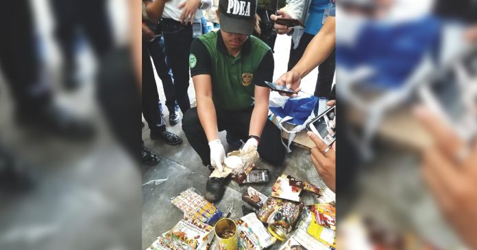 An agent of the Philippine Drug Enforcement Agency-Negros Occidental Provincial Office shows the package containing suspected shabu weighing about 100 grams that was intercepted during their random checking of cargoes at the Bacolod-Silay Airport in Silay City, Negros Occidental on March 7. PDEA REGION VI-WESTERN VISAYAS