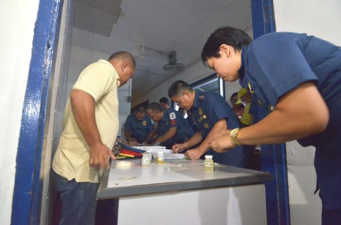 Police officers under the Iloilo City Police Office submit urine samples for drug testing on March 9, 2020. Those who will test positive for illegal drugs face administrative charges and could be removed from the service. IAN PAUL CORDERO/PN