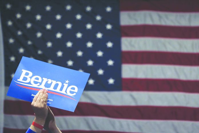 A supporter of Democratic presidential candidate Sen. Bernie Sanders, I-Vt., applauds as Sanders speaks during a campaign rally Monday, March 9, 2020. AP