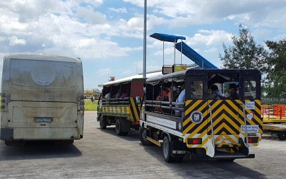 Silay City government provides trucks and a bus to the 84 Negrense persons under monitoring who arrived in Bacolod-Silay Airport in Negros Occidental from Clark International Airport going to a resort on Thursday. They will stay there for a 14-day mandatory quarantine for individuals with possible coronavirus disease 2019 infection. RYAN GAMBOA FACEBOOK PAGE