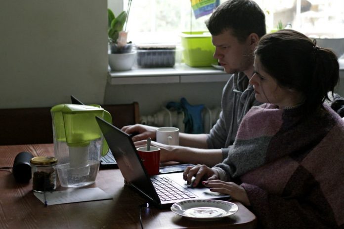 Two people work from home during the outbreak of coronavirus disease, in Gdynia, Poland, Mar. 16, 2020. REUTERS