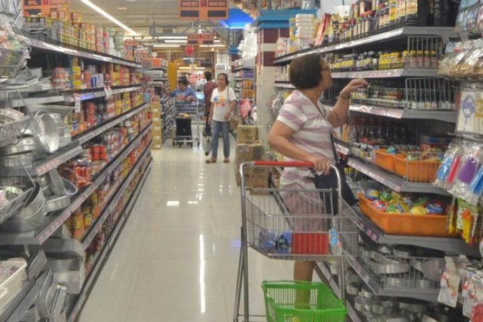 Proclamation 922 which puts the country under a state of public health emergency due to the novel coronavirus outbreak has triggered the implementation of a nationwide price freeze. Photo shows a woman checking prices at a grocery store in Iloilo City. IAN PAUL CORDERO/PN