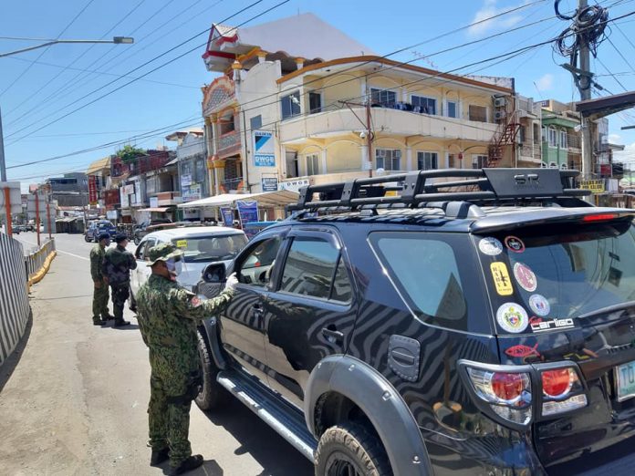 Personnel of the Kalibo municipal police station strictly implement the enhanced community quarantine and check issued quarantine passes of motorists and passengers who enter the border control point in Barangay Poblacion, Kalibo, Aklan on March 28. PNP KALIBO