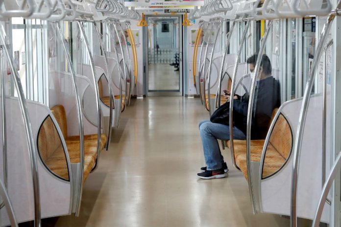 A man wearing a protective face mask sits in a subway train after the government announced a state of emergency for the capital and some prefectures following the coronavirus disease (COVID-19) outbreak, in Tokyo, Japan Apr. 16, 2020. REUTERS