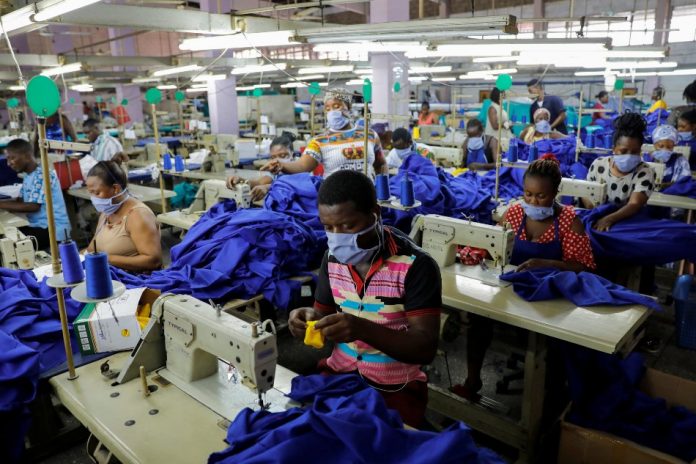 Workers of a local factory begin the production of personal protective gear for local frontline health workers as commissioned by the government, during the partial lockdown in Accra, Ghana April 10, 2020. REUTERS