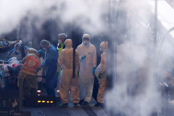 Medical personnel transfer a patient to a TGV high speed train, to continue with the evacuation of people infected with coronavirus disease to western France hospitals, at the Strasbourg railway station, in Strasbourg, France April 3, 2020. REUTERS