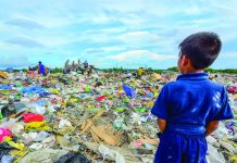 This young boy gazes at the sea of trash in Calajunan Sanitary Landfill, Mandurriao, Iloilo City. This dumpsite became his playground, where he forages for anything of value. Everyday, garbage trucks deliver tons of waste here. IAN PAUL CORDERO/PN