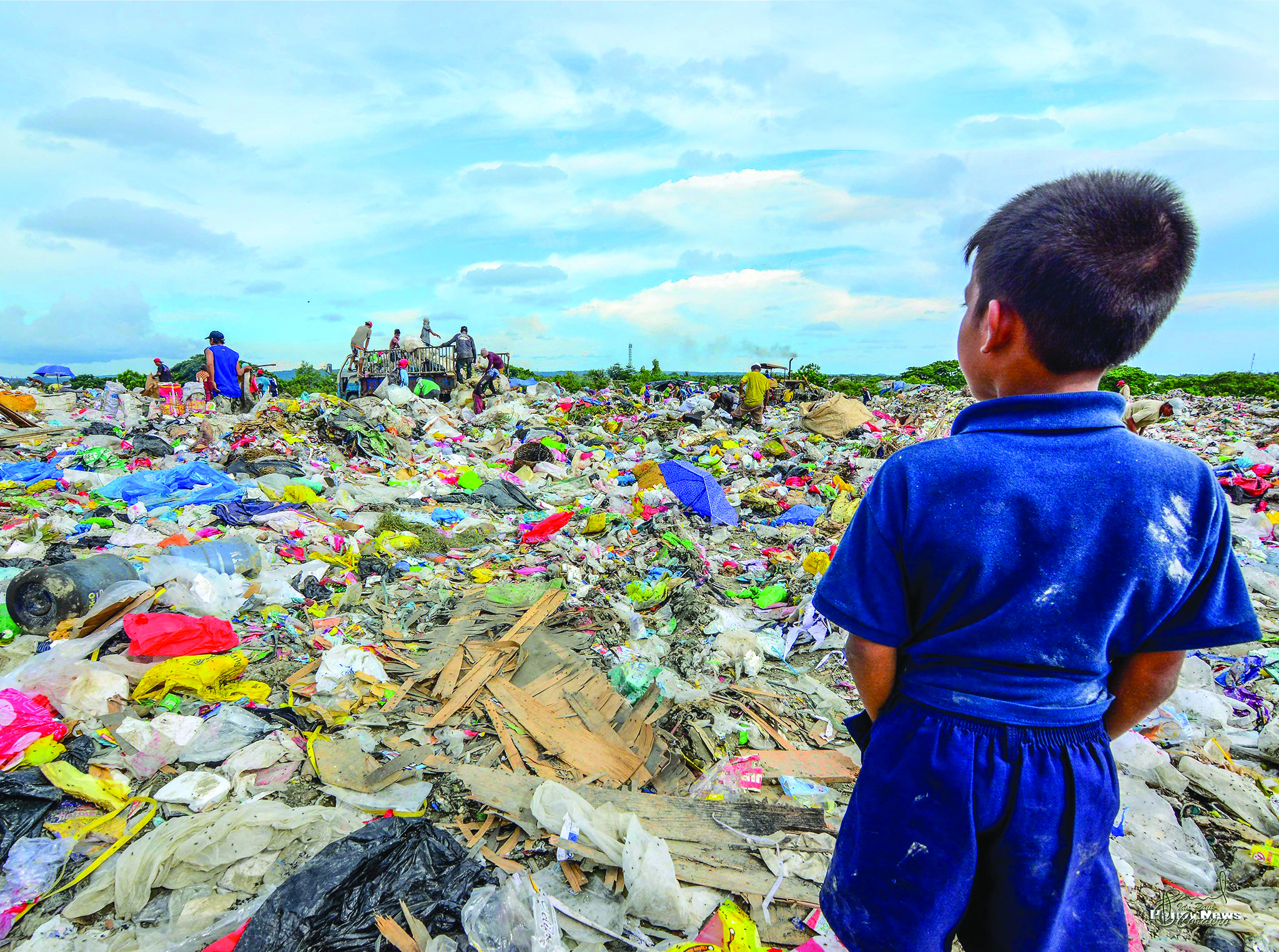 This young boy gazes at the sea of trash in Calajunan Sanitary Landfill, Mandurriao, Iloilo City. This dumpsite became his playground, where he forages for anything of value. Everyday, garbage trucks deliver tons of waste here. IAN PAUL CORDERO/PN