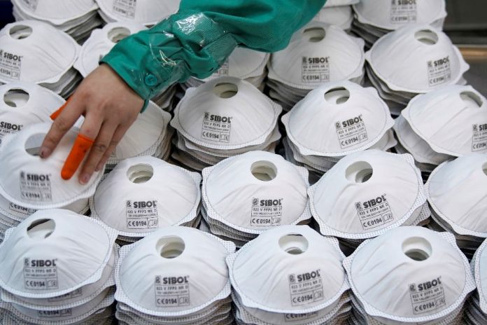 Masks are seen on a production line manufacturing masks at a factory in Shanghai, China Jan. 31, 2020. REUTERS