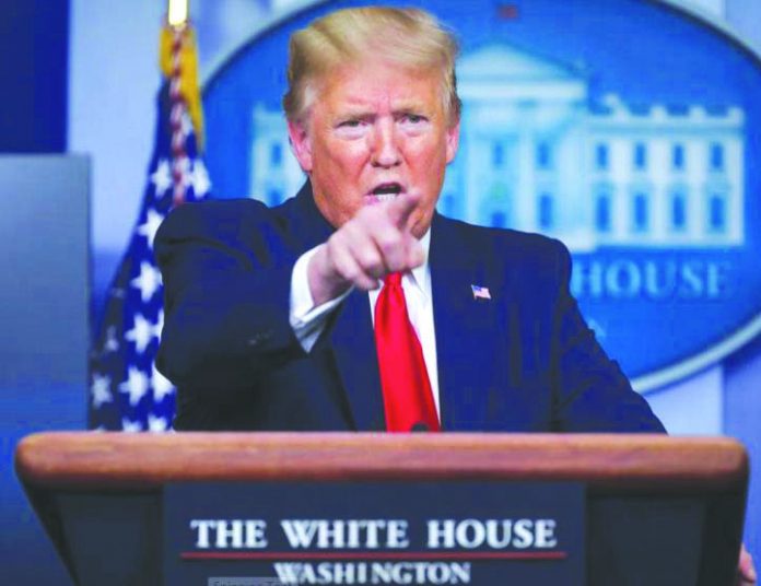 United States President Donald Trump points to a reporter as he answers questions during the daily coronavirus task force briefing at the White House in Washington, U.S. on April 20, 2020. REUTERS