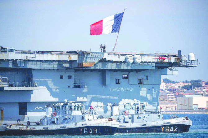 French navy soldiers wearing facemasks stand onboard the French aircraft carrier Charles de Gaulle, as it arrives in the southern French port of Toulon, France with sailors onboard infected with novel coronavirus. AP FILE PHOTO