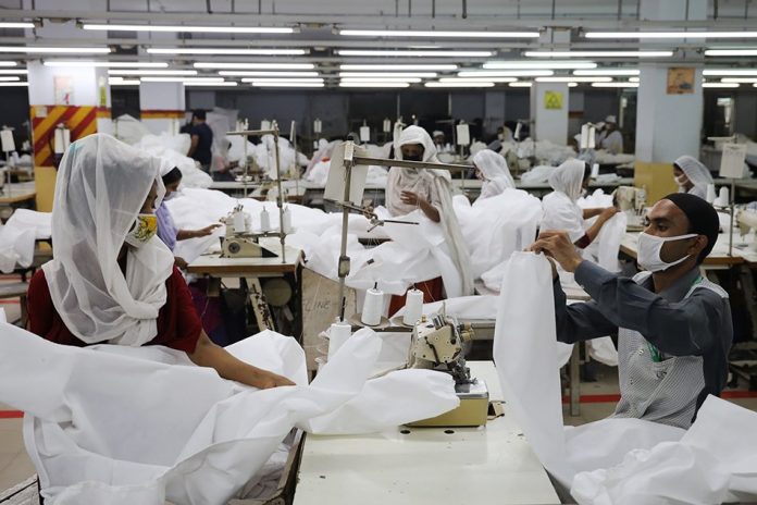 Bangladeshi garment workers make protective suit at a factory amid concerns over the spread of the coronavirus disease in Dhaka, Bangladesh, Mar. 31, 2020. REUTERS