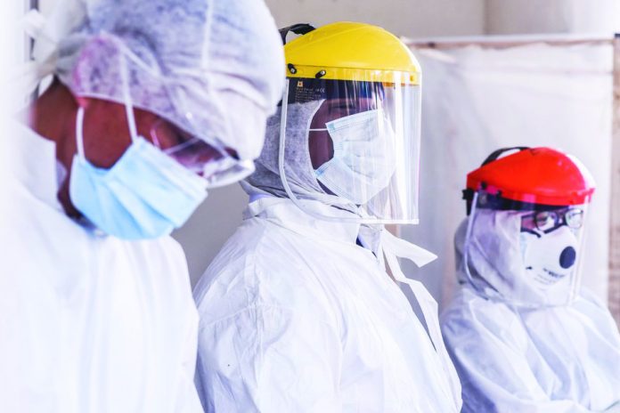 Hospital frontliners wear protective gears as they man the entrance of the emergency room in the Gat Andres Bonifacio Memorial Medical Center in Tondo, Manila. Over 1,000 healthcare workers in the country were positive for coronavirus disease 2019, according to the Department of Health. ABS-CBN NEWS