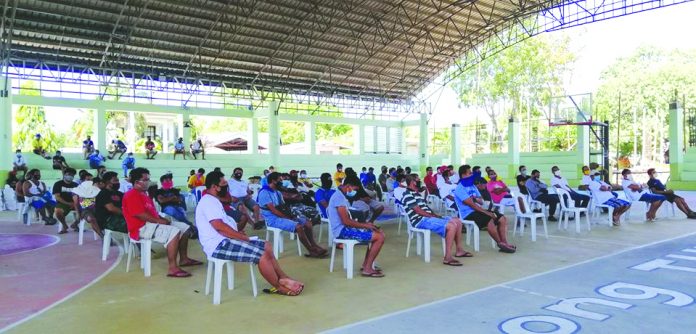 Informal workers in the municipality of Tubungan, Iloilo province, whose sources of income were affected by the coronavirus disease 2019 (COVID-19), attend Department of Labor and Employment’s TUPAD program. The program’s beneficiaries will earn P395 per day in their 10 days work of disinfecting their respective houses to curb the spread of COVID-19. EMZ ESTANDO