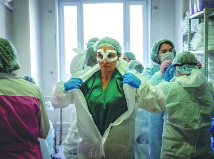 Medical workers get ready for a shift treating coronavirus patients at the Spasokukotsky clinical hospital in Moscow, Russia. AFP