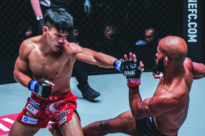 Filipino mixed martial arts fighter Danny Kingad goes for a blow against all-time great Demetrious “Mighty Mouse” Johnson in ONE Flyweight World Grand Prix Championship Final last year. Kingad hopes that he becomes Team Lakay’s ONE world champion this year. ABS-CBN SPORTS