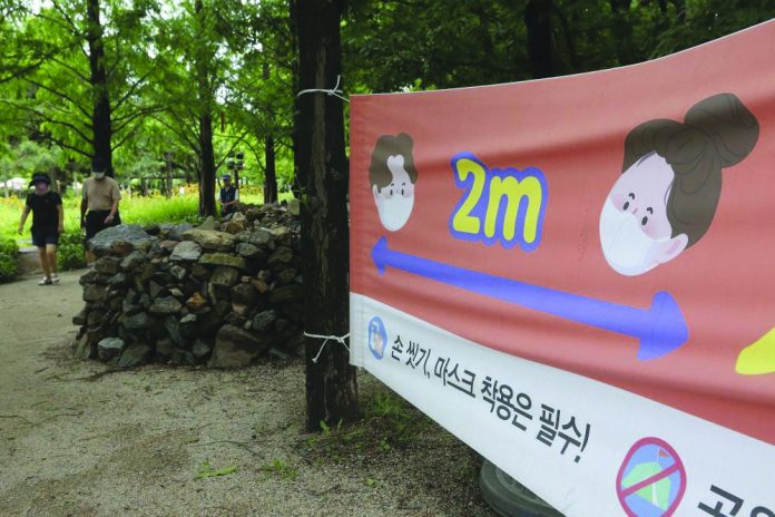 A banner about precautions against the coronavirus disease is displayed at a park in Goyang, South Korea yesterday. The banner reads: "Wash hands and wear face masks." AP