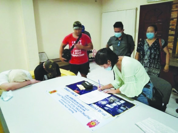 Antidrug personnel conduct inventory of the items seized from John Michael Leonardia and Dindo Barcillo. They were nabbed in an entrapment operation in Barangay Villamonte, Bacolod City on July 10. CDEU/BCPO