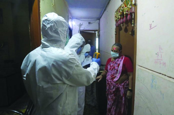 Health workers screen people for COVID-19 symptoms at a residential building in Dharavi, one of Asia's biggest slums, in Mumbai, India on July 17, 2020. AP PHOTO/RAFIQ MAQBOOL