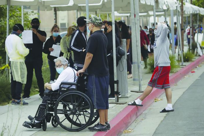 People line up at a mobile Coronavirus testing site at the Charles Drew University of Medicine and Science Wednesday, July 22, 2020, in Los Angeles, California, United States. AP