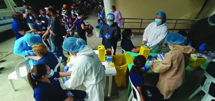 Personnel of the Iloilo City Hall Health Office conduct rapid diagnostic test for coronavirus to city government employees on Monday, July 27. Mayor Jerry Treñas says the testing will ensure the safety of individuals coming in contact with government employees who, in turn, talk and engage with a lot of people while on duty. ARNOLD ALMACEN/CMO